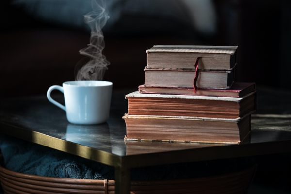 Photo of a coffee mug and books